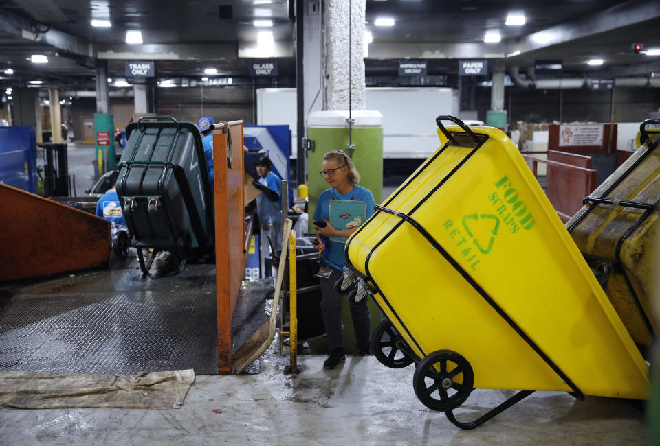 In this March 26, 2019, photo, people work in a recycling area in the back of the house at the Palazzo casino-resort in Las Vegas. The Venetian and Palazzo casino-resorts, which are operated by Las Vegas Sands, send their food scraps to the Las Vegas Livestock pig farm 25 miles north of the Strip. (AP Photo/John Locher)