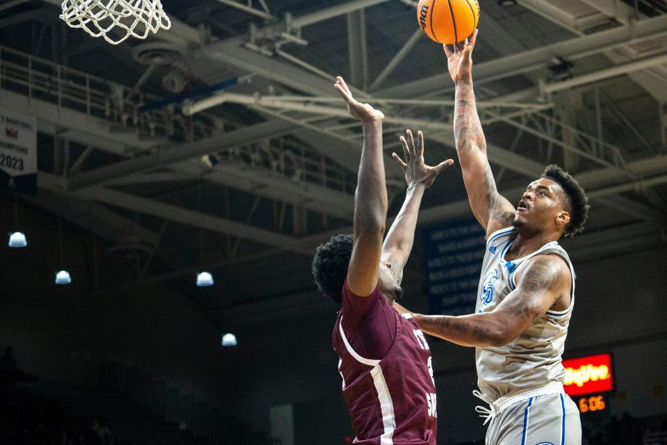 Drake's Darnell Brodie attempts a shot over Texas Southern's Jahmar Young, Jr. during a men's basketball game at the Knapp Center on Saturday, November 25, 2023 in Des Moines.