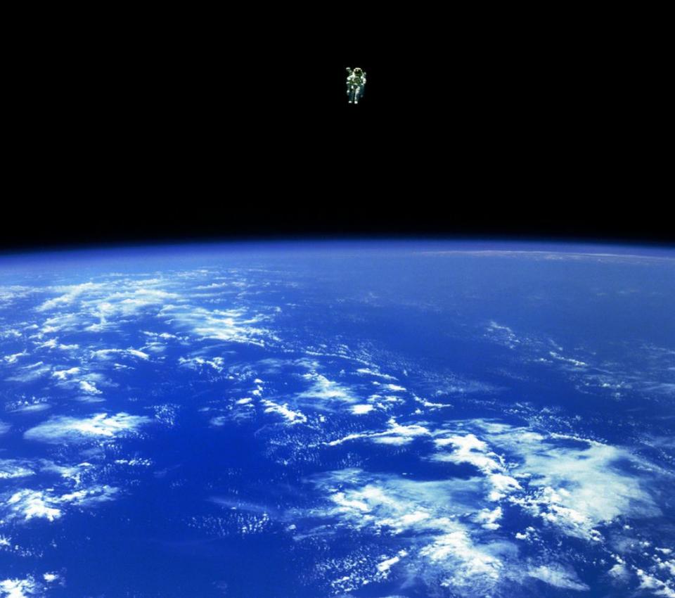 Mission Specialist Bruce McCandless II, is seen further away from the confines and safety of his ship than any previous astronaut has ever been. This space first was made possible by the Manned Manuevering Unit or MMU, a nitrogen jet propelled backpack. After a series of test maneuvers inside and above Challenger's payload bay, McCandless went "free-flying" to a distance of 320 feet away from the Orbiter. This stunning orbital panorama view shows McCandless out there amongst the black and blue of Earth and space. (02/12/1984)