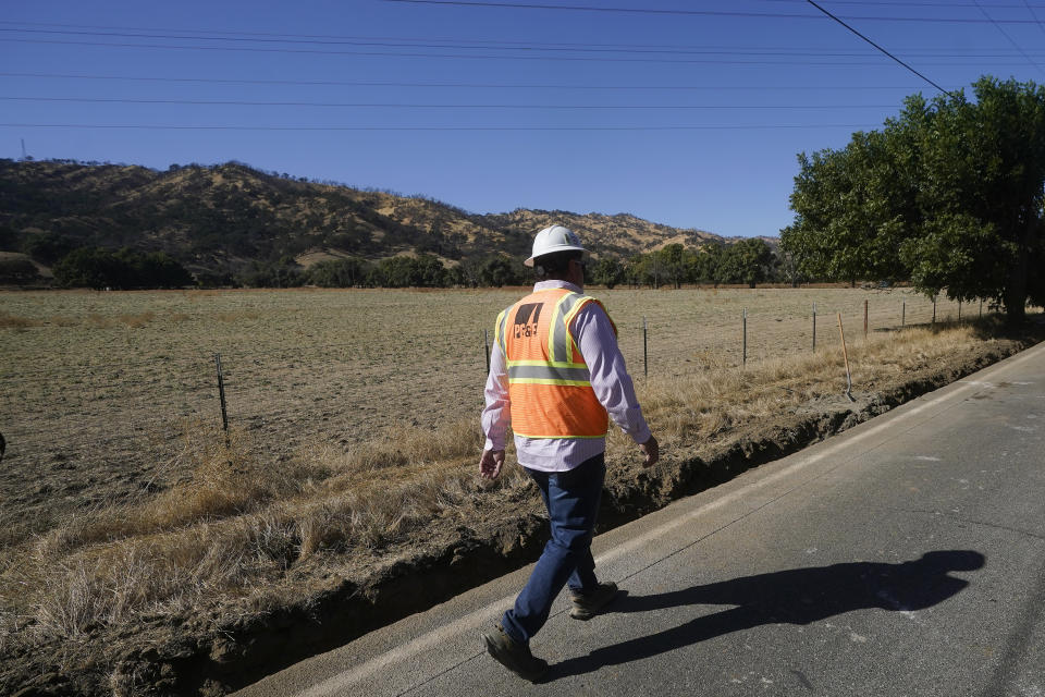 Construction manager Jim Stack walks during a tour of Pacific Gas and Electric workers burying power lines in Vacaville, Calif., Wednesday, Oct. 11, 2023. PG&E wants to bury many of its power lines in areas threatened by wildfires. (AP Photo/Jeff Chiu)