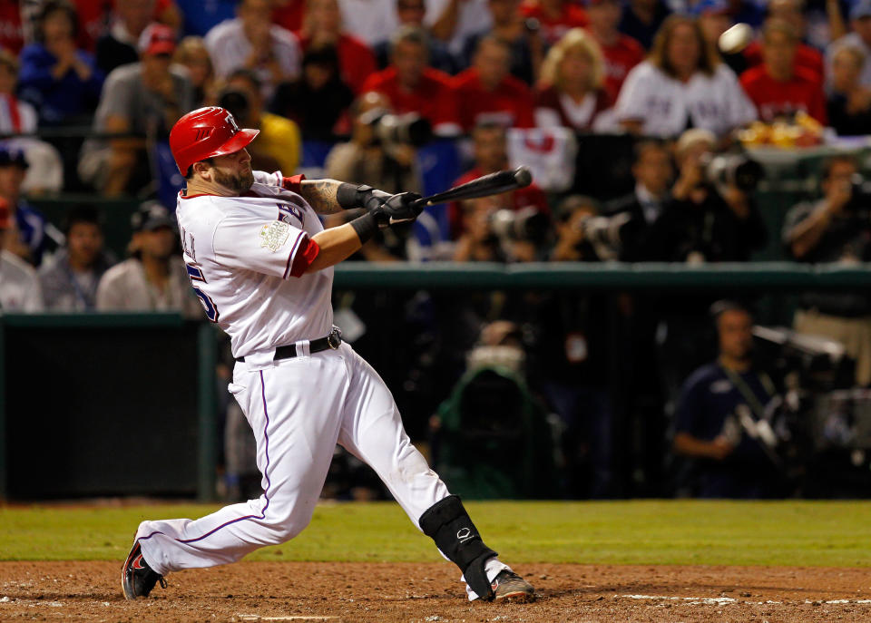 ARLINGTON, TX - OCTOBER 23: Mike Napoli #25 of the Texas Rangers hits a three-run home run in the sixth inning during Game Four of the MLB World Series against the St. Louis Cardinals at Rangers Ballpark in Arlington on October 23, 2011 in Arlington, Texas. (Photo by Tom Pennington/Getty Images)