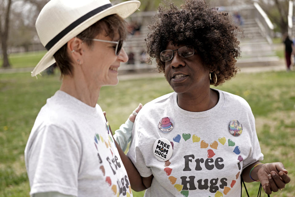 Teresa Parks talks with a friend at the Little Apple Pride festival Saturday, April 23, 2022, in Manhattan, Kan. Inspired by protests following the death of George Floyd, parks co-founded a Black Lives Matter group and as part of a task force has pushed for more inclusion for people from diverse backgrounds in the predominantly white community. (AP Photo/Charlie Riedel)