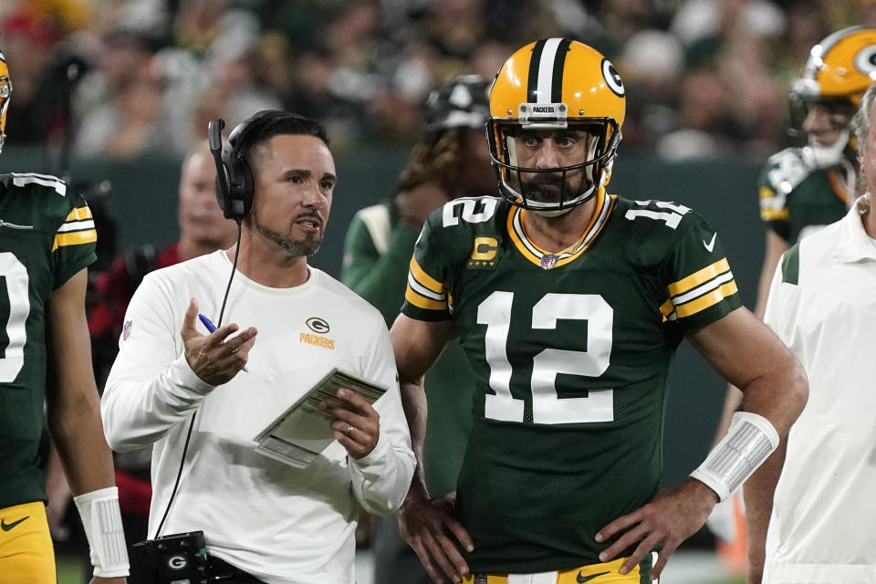 Green Bay Packers head coach Matt LaFleur, left, makes a scrimmage that quarterback Aaron Rodgers currently doesn't seem to agree about love.  (AP Photo/Morry Gash)