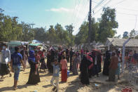 Rohingya refugees who are being moved to an island called ‘Bhasan Char’ gather outside a transit area where they are temporally housed in Ukhiya, Bangladesh, Thursday, Dec.3, 2020. (AP Photo/ Shafiqur Rahman)