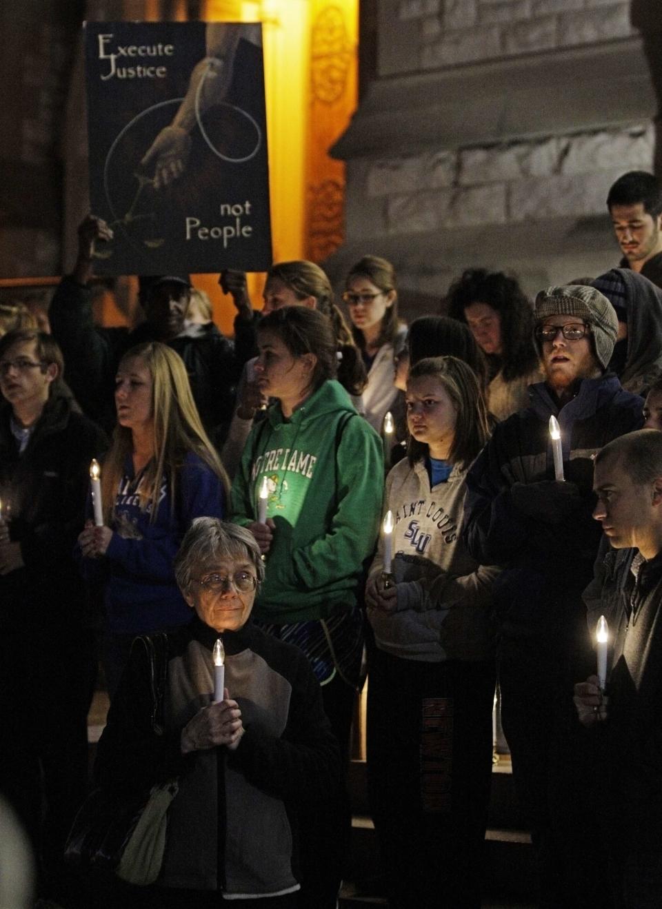 Margaret Phillips, Chairwoman of the local chapter of "Missourians for Alternatives to the Death Penalty" (MADP) (front center),attends a candlelight vigil for death row inmate Joseph Franklin on the steps of St. Francis Xavier Church in St. Louis