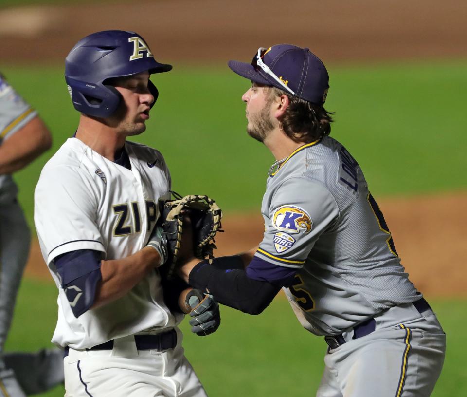 Kent State first baseman Aidan Longwell (5) applies the tag to Akron batter Ian Pennington (16) to end an NCAA baseball game at Canal Park, Tuesday, May 9, 2023, in Akron, Ohio.