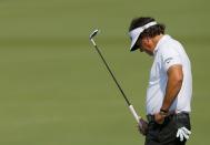 U.S. golfer Phil Mickelson reacts after missing his birdie putt on the second hole during the second round of the Masters golf tournament at the Augusta National Golf Club in Augusta, Georgia April 11, 2014. REUTERS/Brian Snyder (UNITED STATES - Tags: SPORT GOLF)