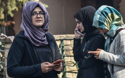 Missing journalist Jamal Khashoggi's Turkish fiancee Hatice (L) and her friends wait in front of the Saudi Arabian consulate in Istanbul - Credit: AFP