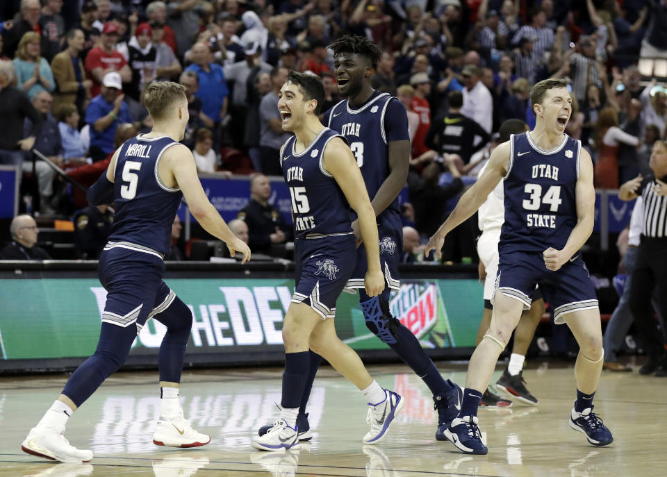 Utah State reacts after Sam Merrill (5) sunk a 3-point basket with seconds remaining in the second half of an NCAA college basketball game for the Mountain West Conference men's tournament championship Saturday, March 7, 2020, in Las Vegas. (AP Photo/Isaac Brekken)