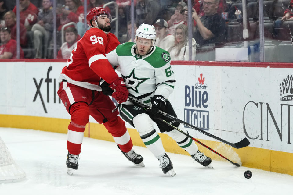 Detroit Red Wings' Jake Walman (96) defends Dallas Stars right wing Evgenii Dadonov (63) in the third period of an NHL hockey game Monday, April 10, 2023, in Detroit. (AP Photo/Paul Sancya)