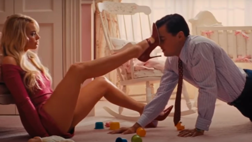 Margot Robbie putting her heel on Leonardo DiCaprio's head in Wolf Of Wall Street