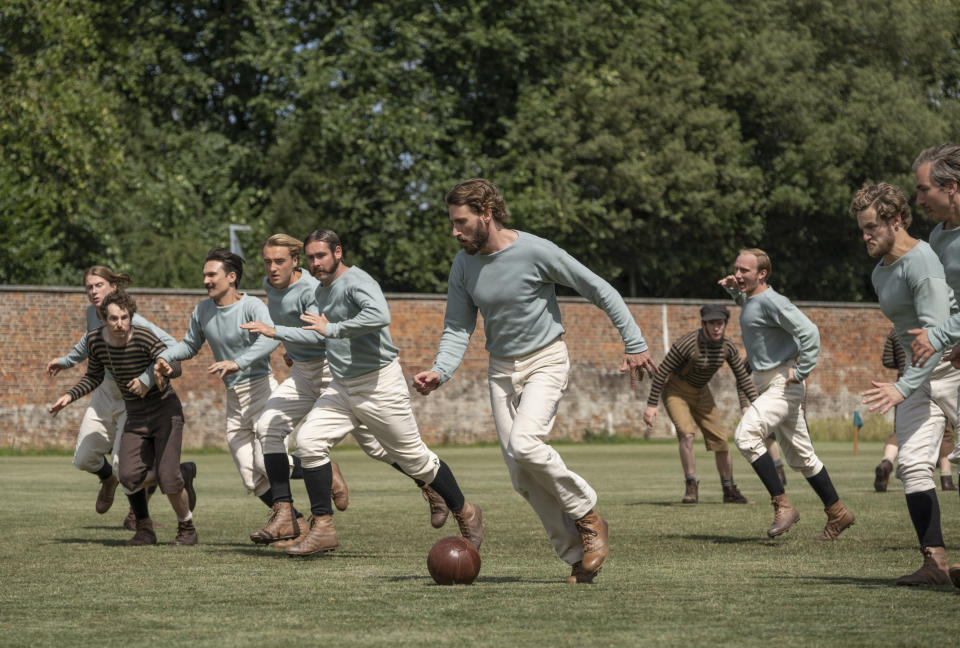 This image released by Netflix shows Edward Holcroft, foreground, in a scene from "The British Game," a six-part drama charting the origins of soccer. (Oliver Upton/Netflix via AP)