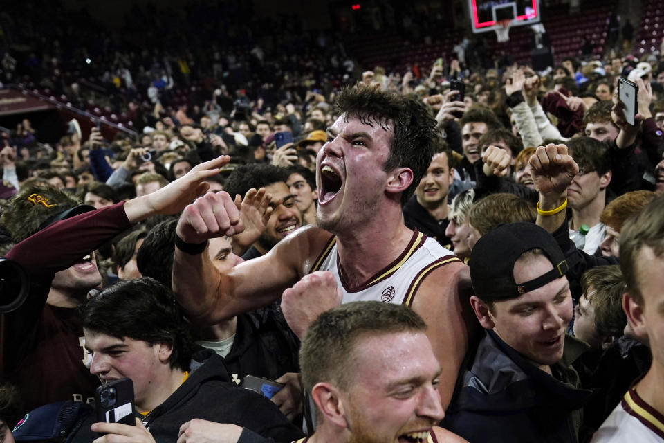 Boston College forward Quinten Post celebrates with fans after upsetting Virginia 63-48 after an NCAA college basketball game, Wednesday, Feb. 22, 2023, in Boston. (AP Photo/Charles Krupa)