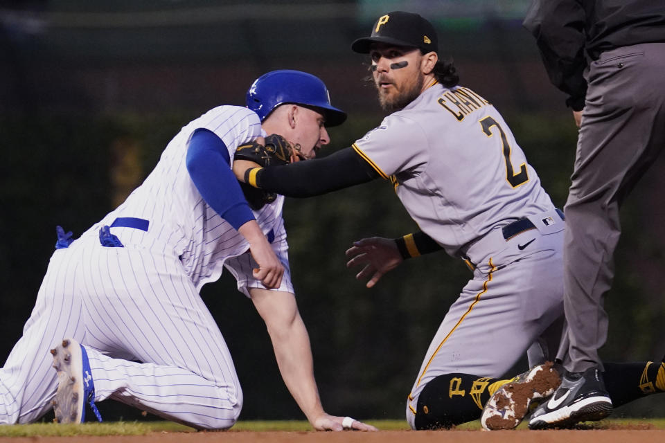 Pittsburgh Pirates second baseman Michael Chavis, right, tags out Chicago Cubs first baseman Frank Schwindel during the fourth inning of a baseball game in Chicago, Wednesday, May 18, 2022. (AP Photo/Nam Y. Huh)