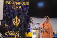 Aasees Kaur, legal client and community services manager of the Sikh Coalition reads a statement on the groups response after the group met at the Sikh Satsang of Indianapolis in Indianapolis, Saturday, April 17, 2021 to formulate the groups response to the shooting at a FedEx facility in Indianapolis that claimed the lives of four members of the Sikh community. A gunman killed eight people and wounded several others before taking his own life in a late-night attack at a FedEx facility near the Indianapolis airport, police said. (AP Photo/Michael Conroy)