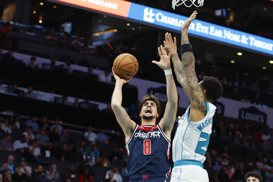 Washington Wizards forward Deni Avdija (8) shoots against Charlotte Hornets forward P.J. Washington during the first half of an NBA basketball game in Charlotte, N.C., Wednesday, Nov. 8, 2023. (AP Photo/Nell Redmond)