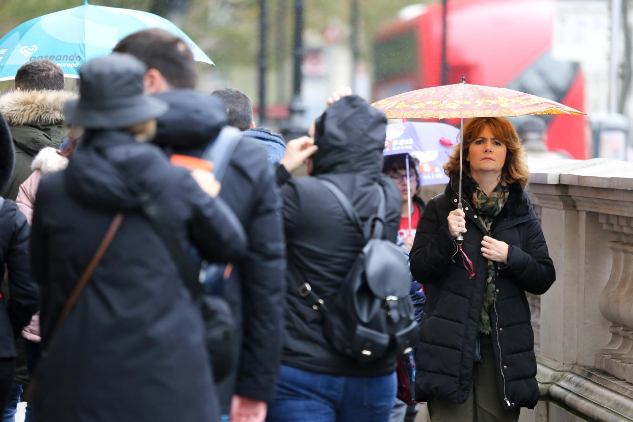 LONDON, UNITED KINGDOM - 2019/11/01: A woman shelters from the rain underneath an umbrella on a wet day.  70mm rain expected as UK braces for heavy showers and gale force winds this weekend. (Photo by Steve Taylor/SOPA Images/LightRocket via Getty Images)