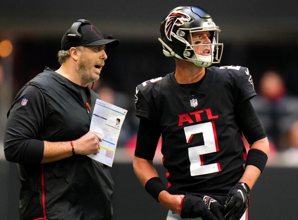 Head coach Arthur Smith of the Atlanta Falcons and Matt Ryan #2 meet in the fourth quarter against the Carolina Panthers at Mercedes-Benz Stadium on October 31, 2021 in Atlanta, Georgia.