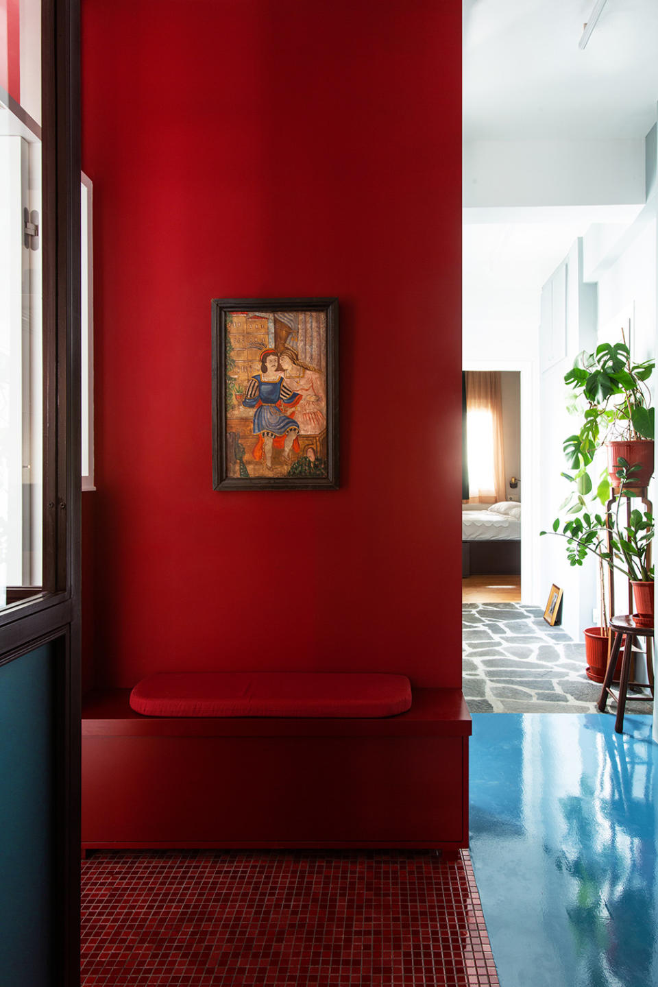 red entryway with built in bench