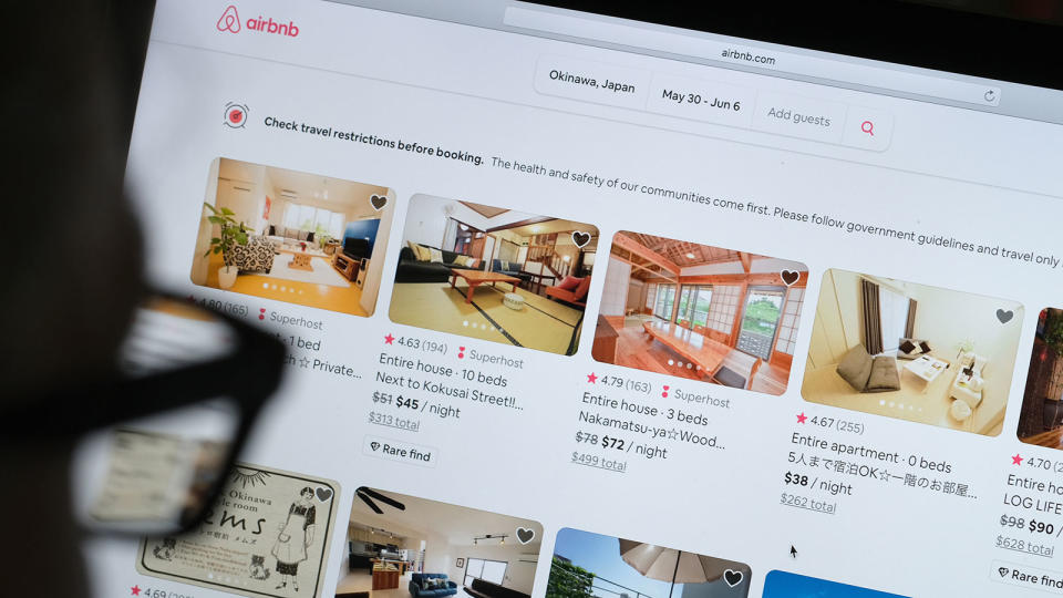 man looks at the Airbnb website