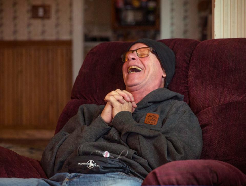 Steve Connelly laughs as he talks about the happy moments in his life during a counseling session with his death doula.