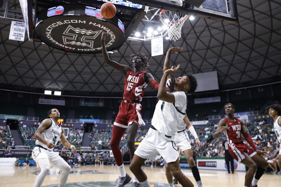 Washington State center Adrame Diongue (15) goes for a rebound against Hawaii during the first half of an NCAA college basketball game Friday, Dec. 23, 2022, in Honolulu. (AP Photo/Marco Garcia)