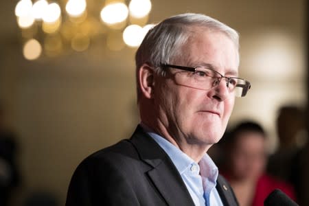 Marc Garneau, Minister of Transport, speaks to the media while he and his cabinet take part in a two-day Liberal retreat in Calgary, Alberta
