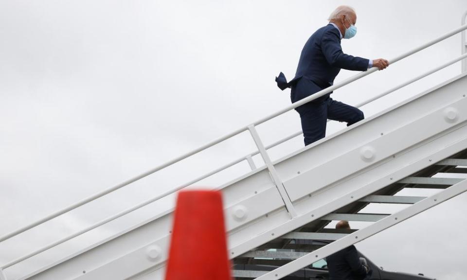 Joe Biden bounds up the steps of a plane in Delaware.