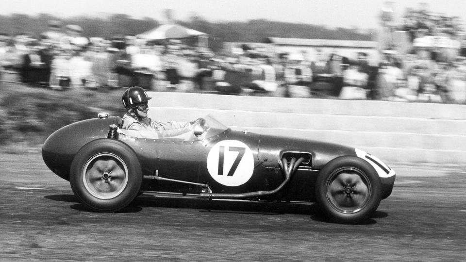 Graham Hill driving a Lotus-Climax Type 12 in the 1958 BRDC International Trophy race at Silverstone, his first Formula 1 contest.