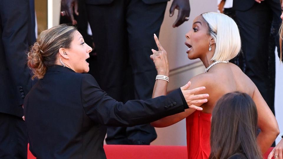 Kelly Rowland and security guard on carpet