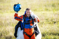 Swiss adventurer Raphael Domjan reacts upon landing after he jumped with a parachute from the SolarStratos solar powered aircraft prototype with Spanish test pilot Miguel A. Iturmendi aboard during a test flight and attempt to break two world records at the airbase in Payerne, Switzerland, Tuesday, Aug. 25, 2020. Two world record were made during today's test flight, the first jump in history from an electric aircraft exclusively charged with solar energy and the first solar free fall. The main objective of the SolarStratos Mission project is to be the first solar flight to achieve stratospheric flight. (KEYSTONE/Jean-Christophe Bott)