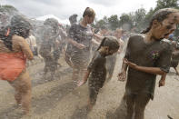 <p>Kids wash off after playing in the mud during Mud Day at the Nankin Mills Park, July 11, 2017 in Westland, Mich. (Photo: Carlos Osorio/AP) </p>