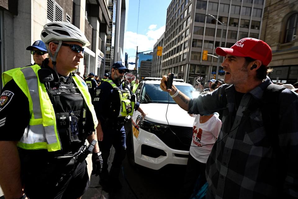Livestreamer Chris Dacey yells at police =during a rally against LGBTQ-inclusive education policies on Sept. 20, 2023 in Ottawa.