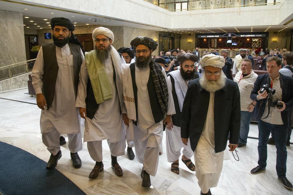 FILE - In this May 28, 2019 file photo, Mullah Abdul Ghani Baradar, the Taliban group's top political leader, third from left, arrives with other members of the Taliban delegation for talks in Moscow, Russia. The Taliban said Tuesday, Oct. 22, 2019, that a fresh round of intra-Afghan peace talks is to be held in China next week. The announcement raises hopes for renewed negotiations, even as violence surges in Afghanistan’s 18-year war. Suhail Shaheen, spokesman for the Taliban’s political office in Qatar, said Tuesday that the talks are planned for Oct. 28 and 29. (AP Photo/Alexander Zemlianichenko, File)