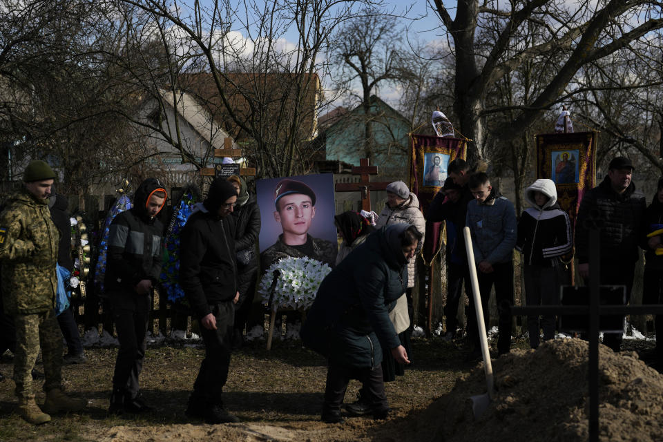 A picture of Vladyslav Bondarenko 26, is on display during his funeral in Kozyntsi, near Kyiv, Ukraine, Monday, March 6, 2023. Bondarenko, a paratrooper of airmobile brigade, died near Bakhmut on Feb 26. (AP Photo/Thibault Camus)