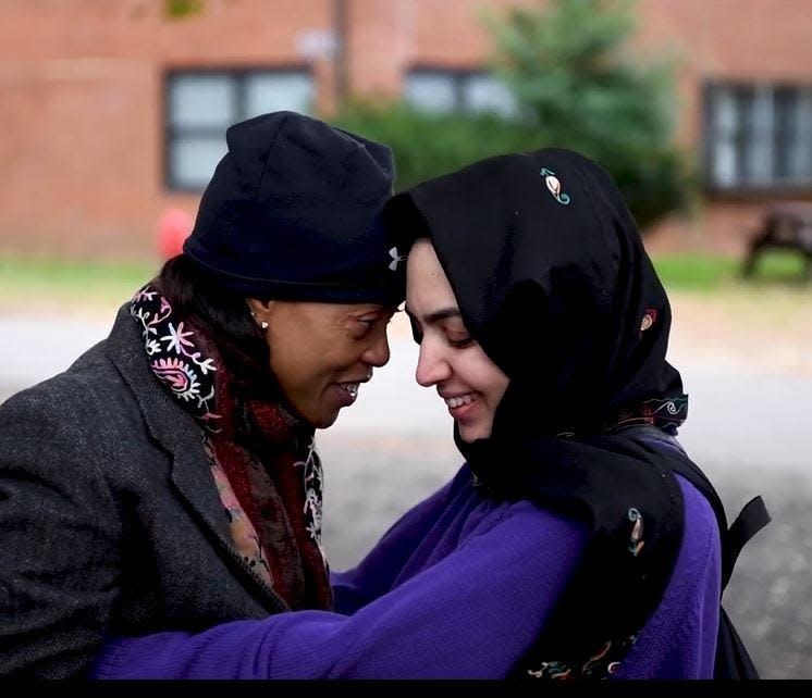 Hope Williams, right, a USAID staffer who worked in Afghan, reunites with Miriam, an Afghan friend, at Joint Base McGuire-Dix-Lakehurst.