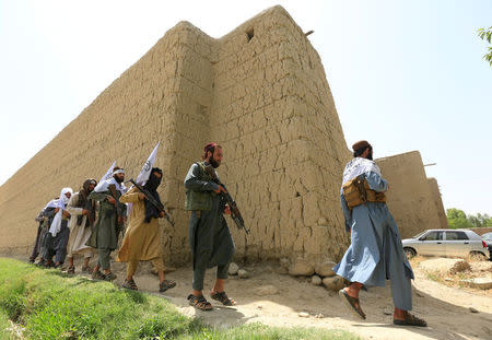 Taliban walk as they celebrate ceasefire in Ghanikhel district of Nangarhar province, Afghanistan June 16, 2018. REUTERS/Parwiz