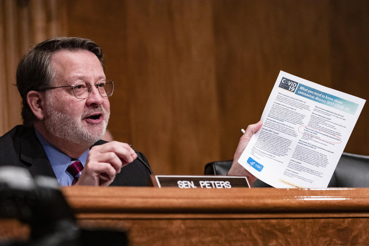 Ranking Member Gary Peters (D-MI) holds a leaflet from the Centers for Disease and Control (CDC) on COVID-19 while questioning Ken Cuccinelli (not pictured), senior official performing the duties of the deputy Homeland Security secretary(Samuel Corum/Getty Images) 