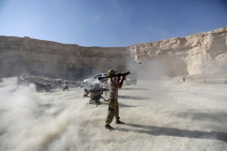 FILE PHOTO: Fighters from Free Syrian Army (National Brigade) demonstrate their skills during a military display as part of a graduation ceremony in the Syrian city of al-Bab