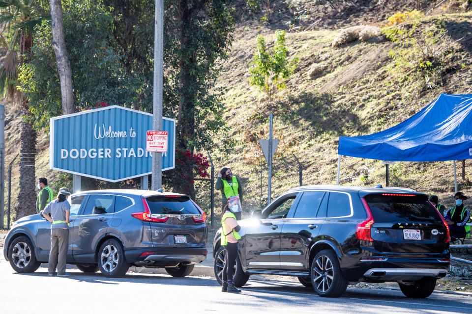 LOS ANGELES, CA - JANUARY 15: CORE employees direct traffic at Dodger Stadium  in Los Angeles after it was turned into a COVID-19 drive-thru vaccination site on Friday, January 15, 2021. (Photo by Sarah Reingewirtz, Los Angeles Daily News/SCNG)