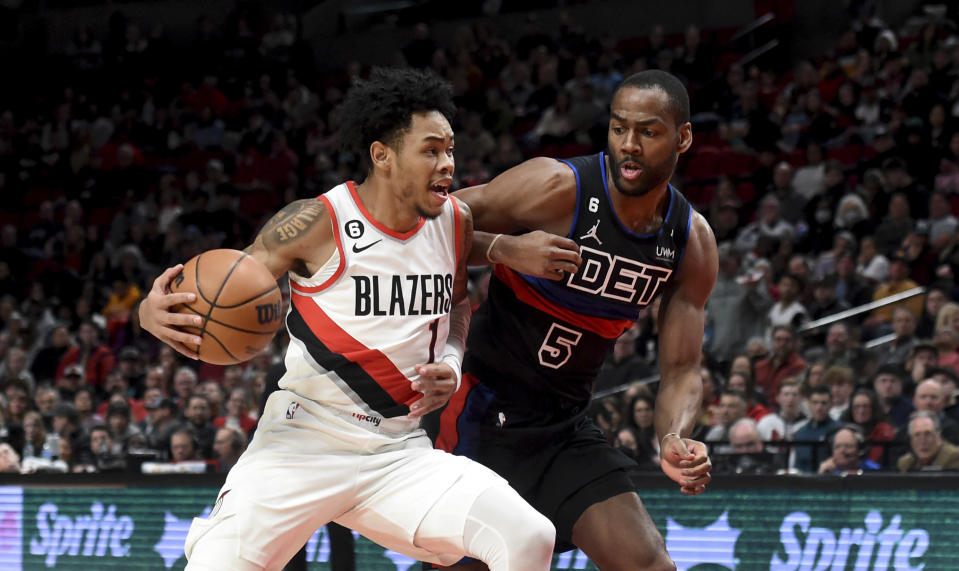 Portland Trail Blazers guard Anfernee Simons, left, drives to the basket on Detroit Pistons guard Alec Burks during the first half of an NBA basketball game in Portland, Ore., Monday, Jan. 2, 2023. (AP Photo/Steve Dykes)