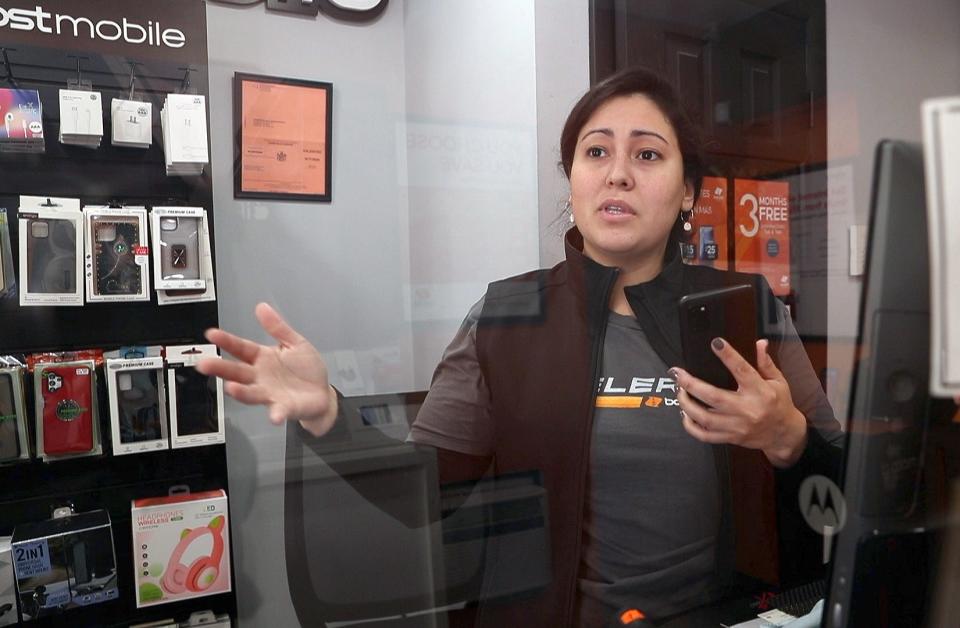 Vanessa Hernandez, who is a Brewster resident and manager of the boost Mobil store on Main Street, talks about the Brewster Crossings project, while in her Main Street business Jan. 31, 2022. Her store would be demolished as part of the project.