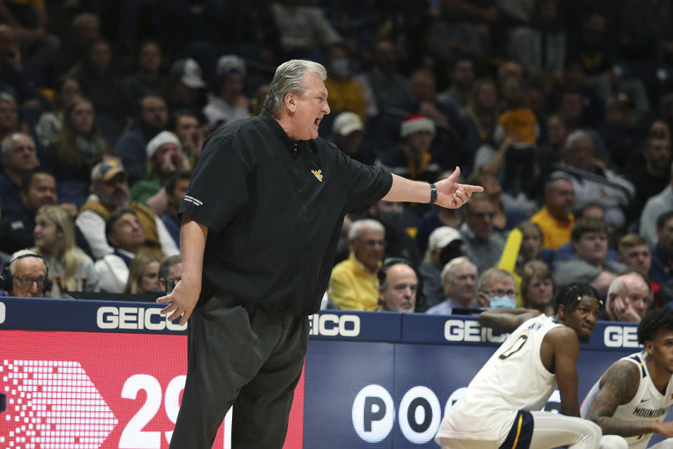 West Virginia coach Bob Huggins gestures during the first half of the team's NCAA college basketball game against Connecticut in Morgantown, W.Va., Wednesday, Dec. 8, 2021. (AP Photo/Kathleen Batten)