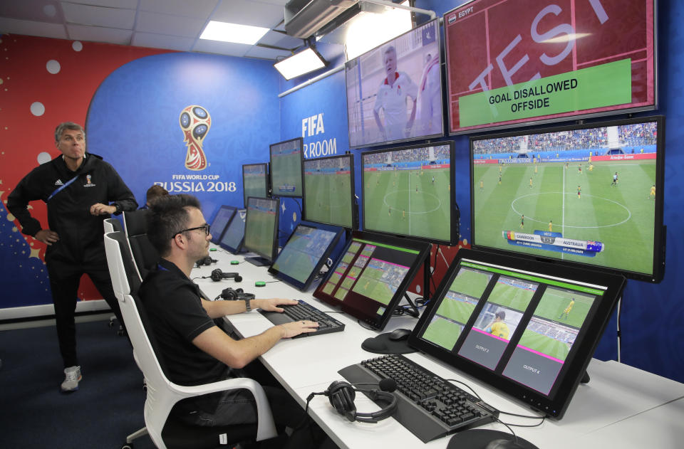 VAR refereeing Project Leader Roberto Rosetti, left, demonstrates a video operation room (VOR), a facility of the Video Assistant Referee (VAR) system which will be rolled out for the first time during theWorld Cup, at the 2018 World Cup International Broadcast Centre in Moscow, Russia, Saturday, June 9, 2018. (AP Photo/Dmitri Lovetsky)