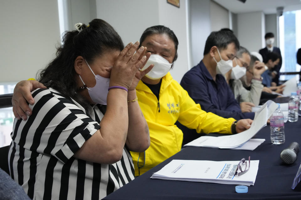 Park Sun-yi, left, a victim of Brothers Home, weeps during a press conference at the Truth and Reconciliation Commission office in Seoul, South Korea, Wednesday, Aug. 24, 2022. The commission has found the country's past military governments responsible for atrocities committed at Brothers Home, a state-funded vagrants' facility where thousands were enslaved and abused from the 1960s to 1980s. (AP Photo/Ahn Young-joon)