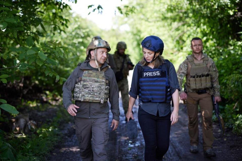 Ukrainian President Volodymyr Zelenskyy walks with CBS News correspondent Holly Williams during a visit to a front line in Donbass, Ukraine, in his country's war with Russian-backed separatists, June 9, 2021. / Credit: Ukrainian Presidency/Handout/Anadolu Agency/Getty