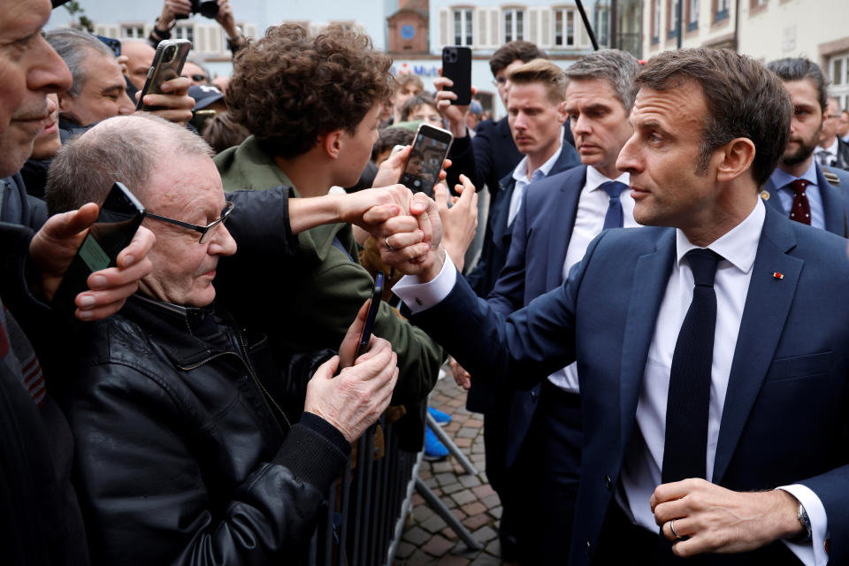 French President Emmanuel Macron cheers residents in Selestat, eastern France, Wednesday, April 19, 2023. (Ludovic Marin, Pool via AP)