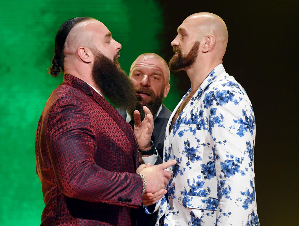 LAS VEGAS, NEVADA - OCTOBER 11:  WWE Executive Vice President of Talent, Live Events and Creative Paul "Triple H" Levesque (C) gets between WWE wrestler Braun Strowman (L) and heavyweight boxer Tyson Fury (R) as they face off during the announcement of their match at a WWE news conference at T-Mobile Arena on October 11, 2019 in Las Vegas, Nevada. Strowman will face Fury and WWE champion Brock Lesnar will take on former UFC heavyweight champion Cain Velasquez at the WWE's Crown Jewel event at Fahd International Stadium in Riyadh, Saudi Arabia on October 31.  (Photo by Ethan Miller/Getty Images)