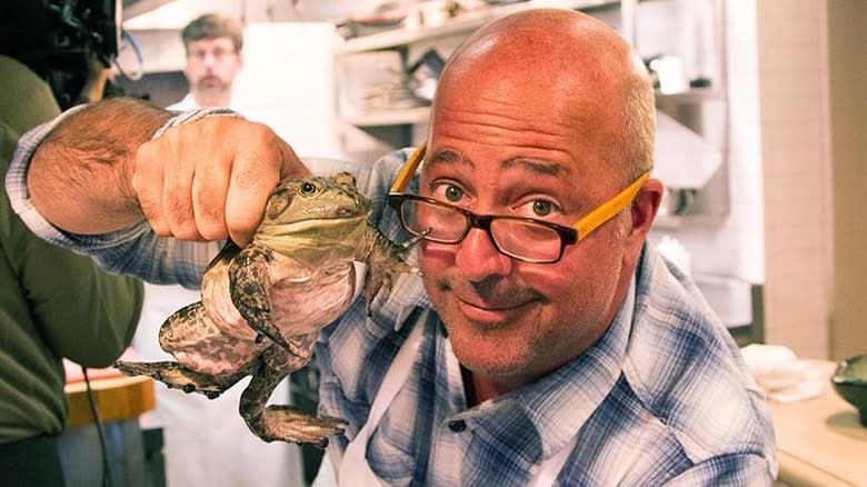 Andrew Zimmern holds bullfrog