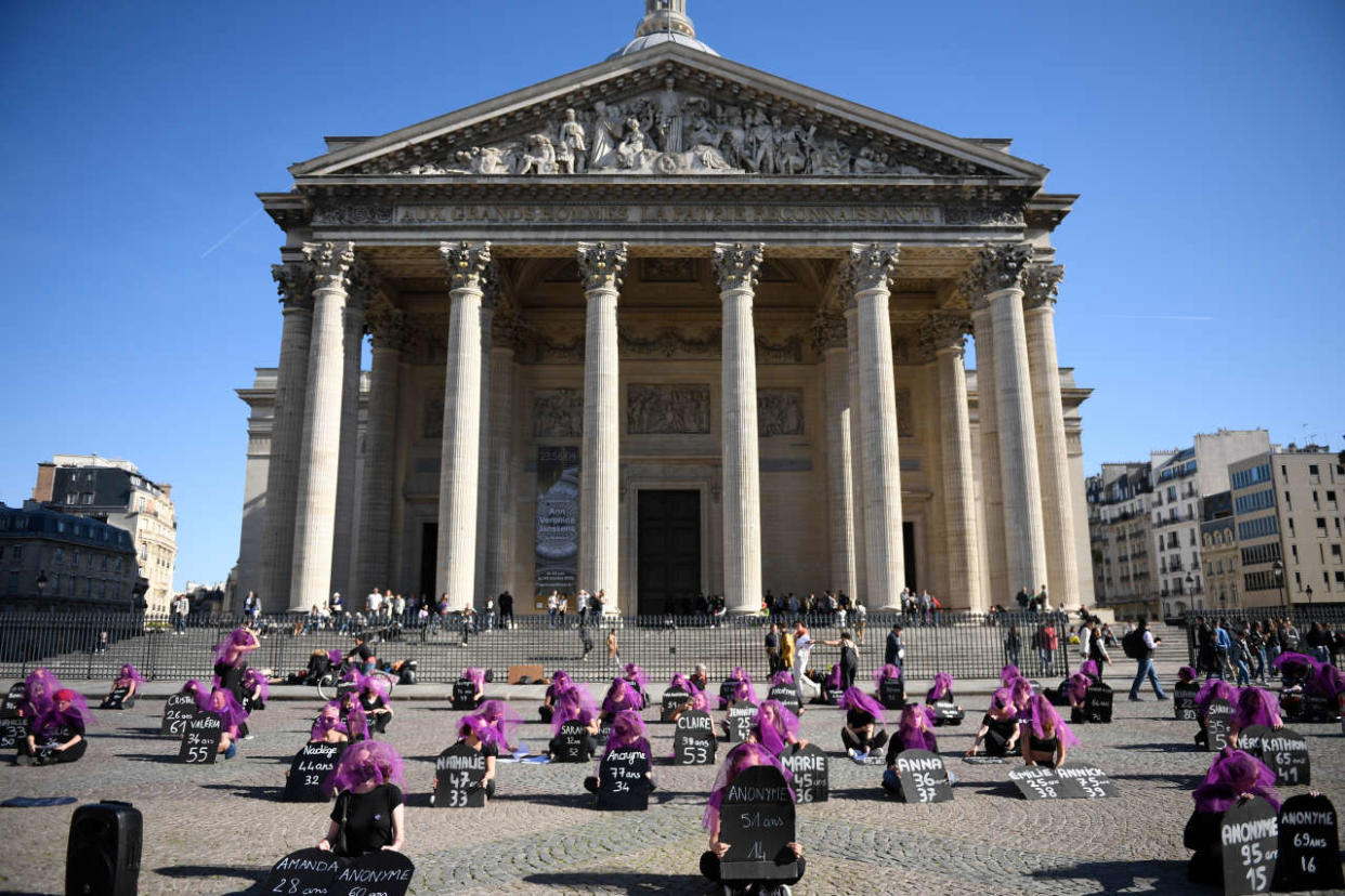 Women activists wearing veils and holding placards with the names and ages of victims, gather at during a rally organised by the collective #NousToutes against feminicides at Place du Pantheon in Paris on October 9, 2022. (Photo by JULIEN DE ROSA / AFP)